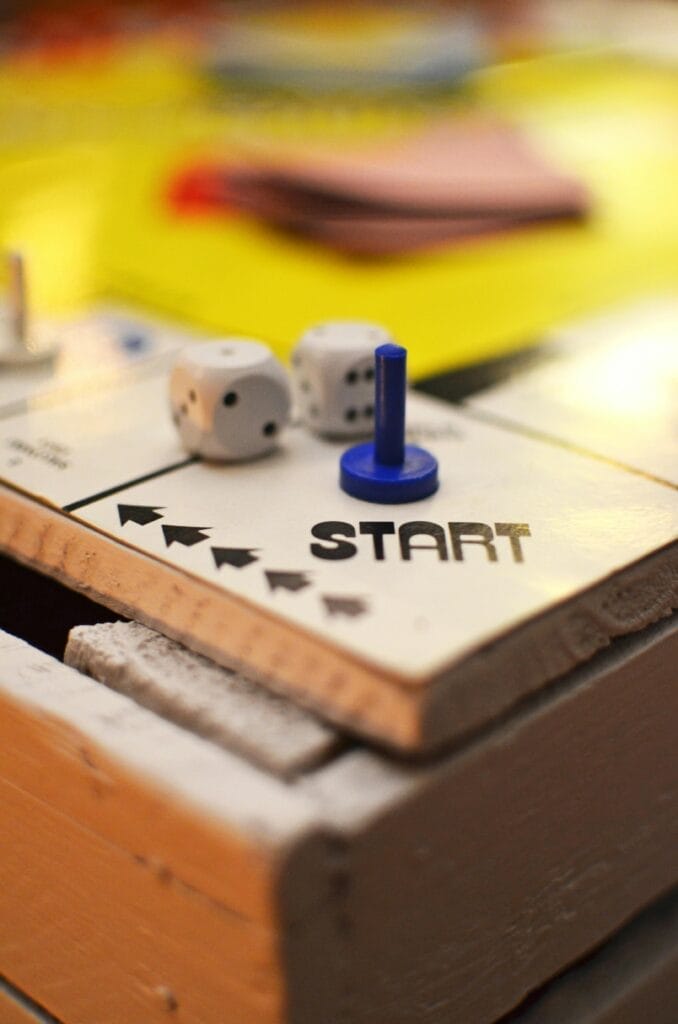young-game-match-kids-2923 Close-up of a board game start position featuring dice and a blue game piece, perfect for leisure themes.